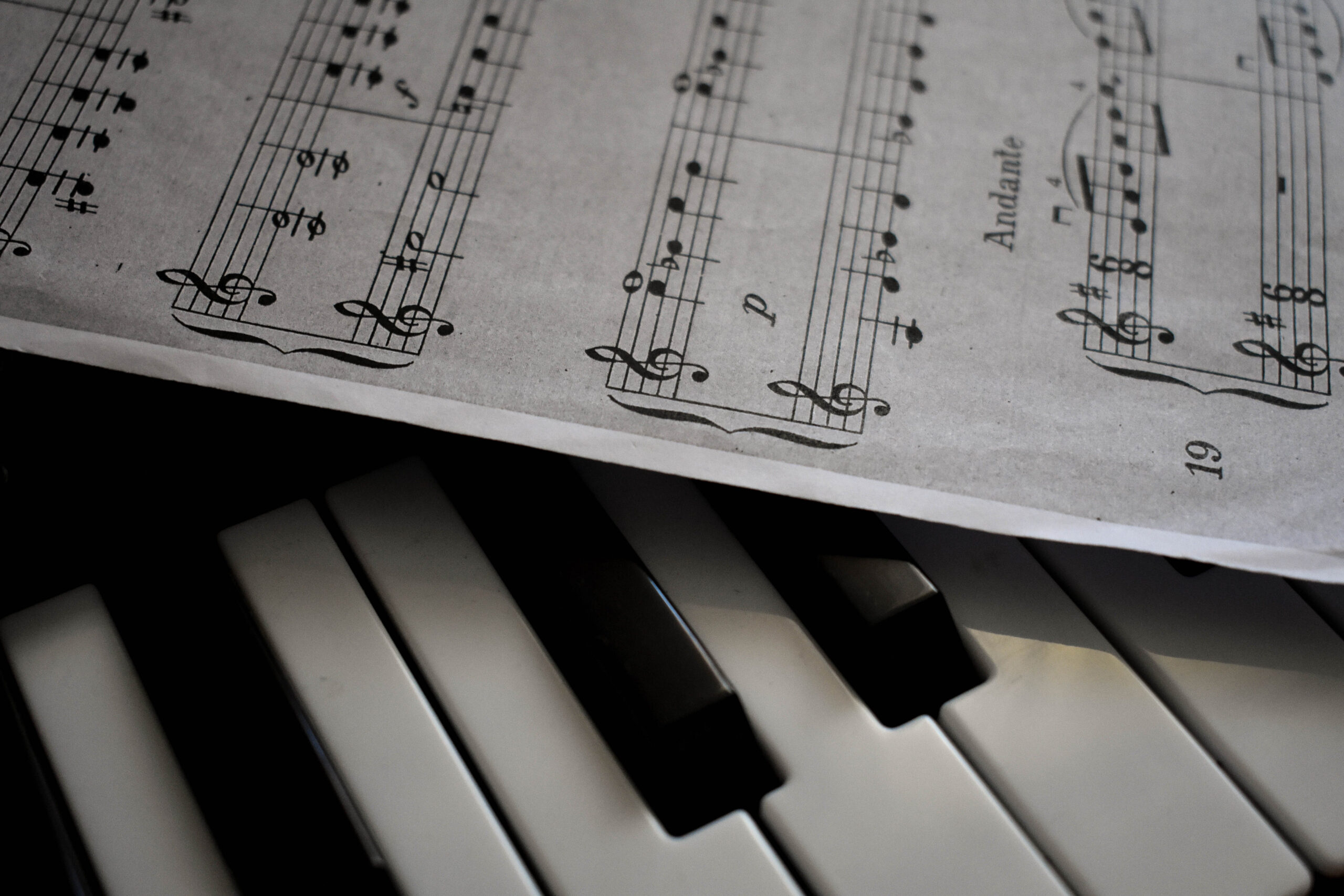 Close-Up Shot of Musical Notes and Piano Keys · Free Stock Photo