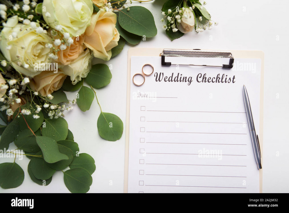 Creative wedding planning checklist with roses and rings Stock