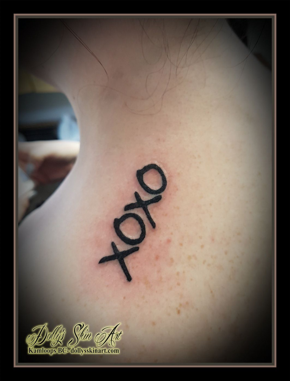 XOXO black lettering font linework shoulder first tattoo kamloops