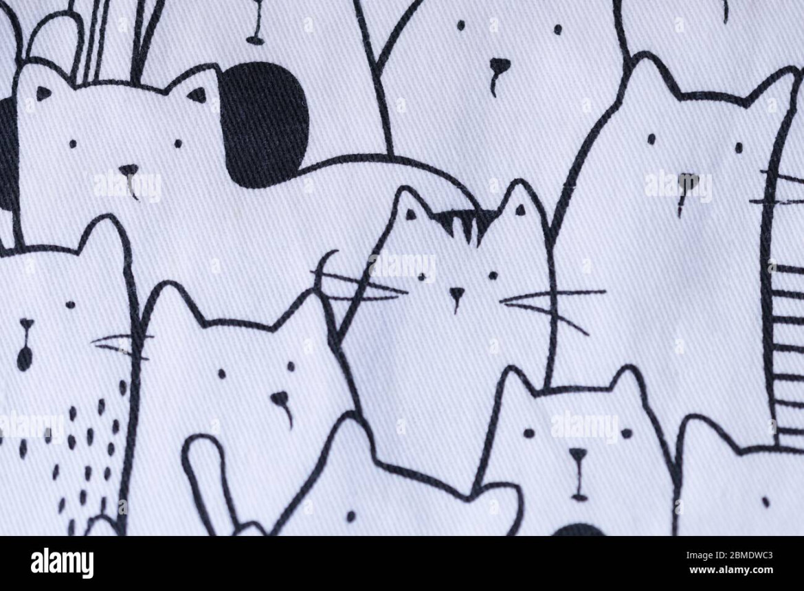 Texture of a white fabric with drawings of cats